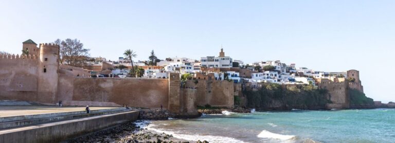 Skyline of Rabat city, Morocco, showcasing historical landmarks like the Hassan Tower and the Royal Palace, along with the Bouregreg River and modern urban areas.