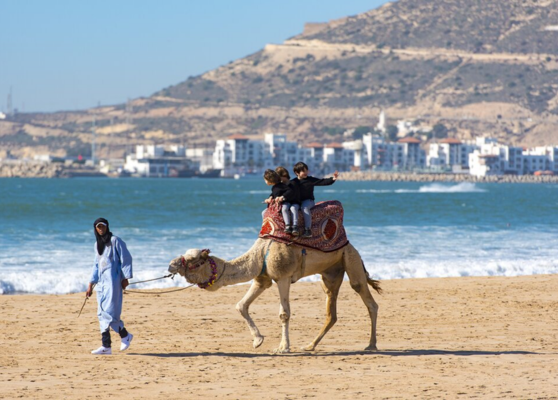 Luxury car driving through the scenic road between Marrakech and Agadir with Atlas Mountains views